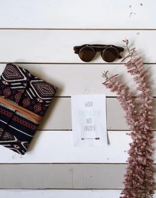A wallet and eyeglasses on a table