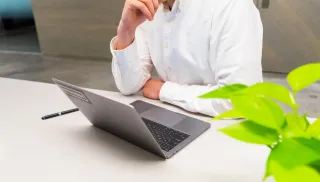 A person considering work at a laptop