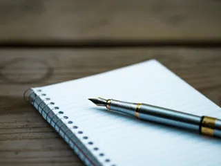 A pen and notebook for financial planning